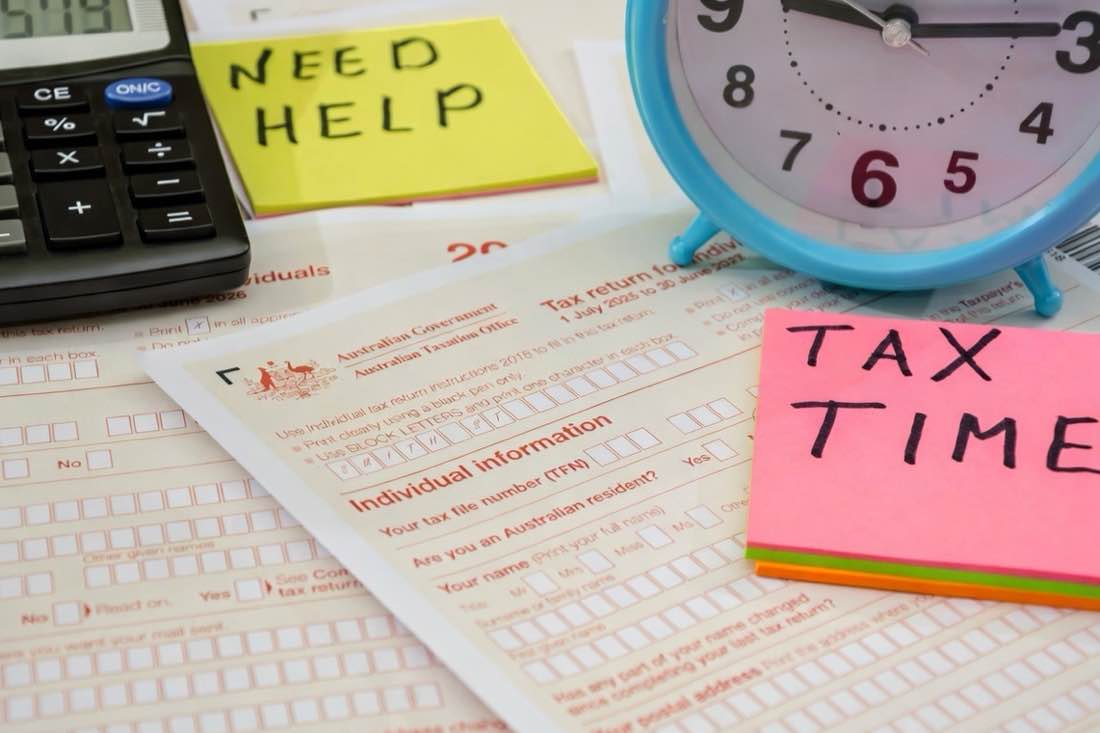 Australian Taxation Office 2026 individual tax return form with calculator, clock, and Need Help and Tax Time sticky notes