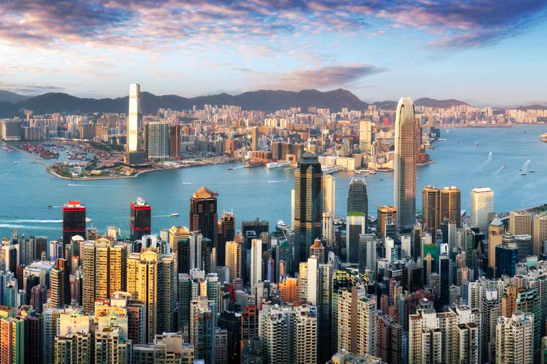 Hong Kong skyline and Victoria Harbour viewed from Victoria Peak at sunset, representing Australian relocation to Hong Kong after the 2026 Budget changes to capital gains tax.